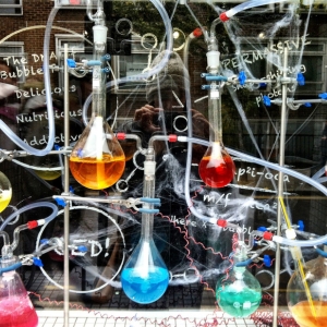 lab apparatus, retort stands and conical flasks containing colored chemicals